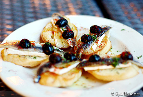 Cold tapas: Olive, anchovy & melted Brie cheese on toast